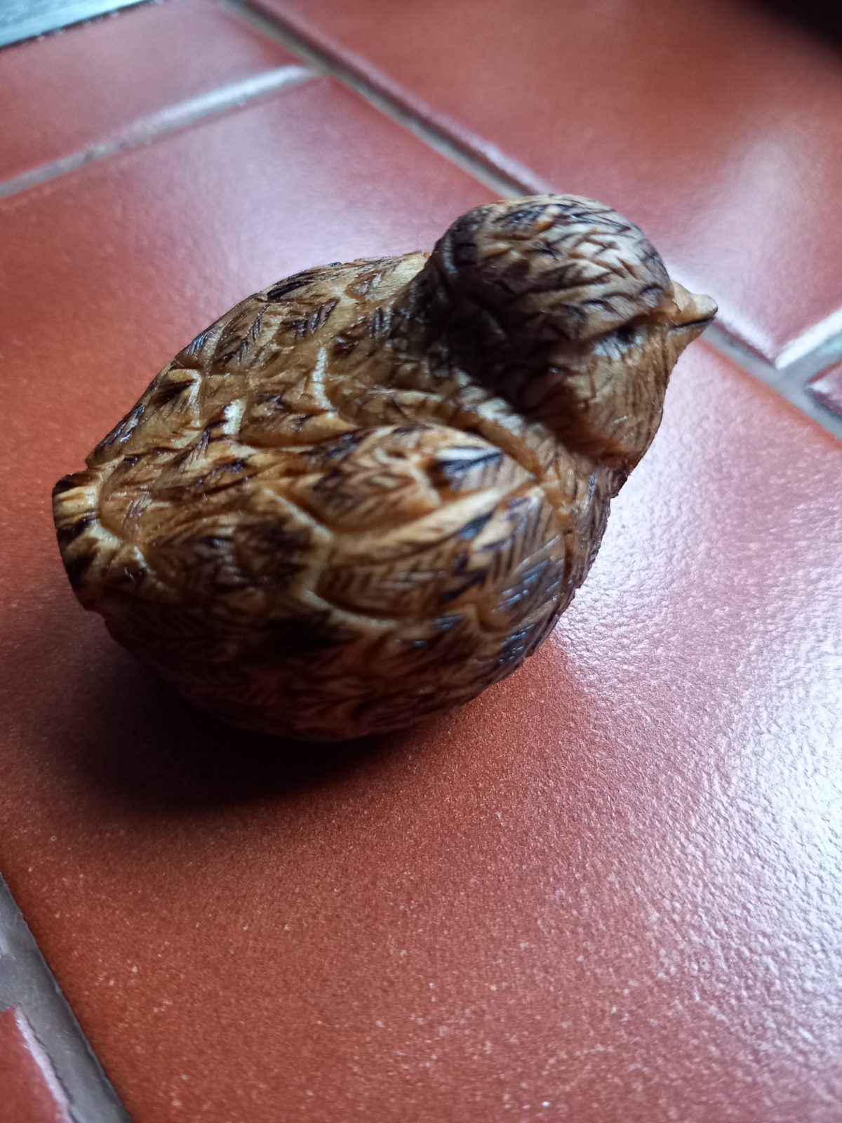 Small carved bird with textured feathers