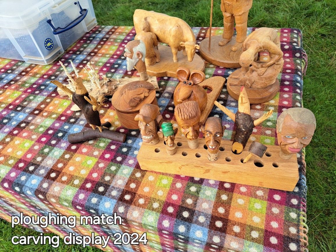 Table display of many club woodcarvings outdoors