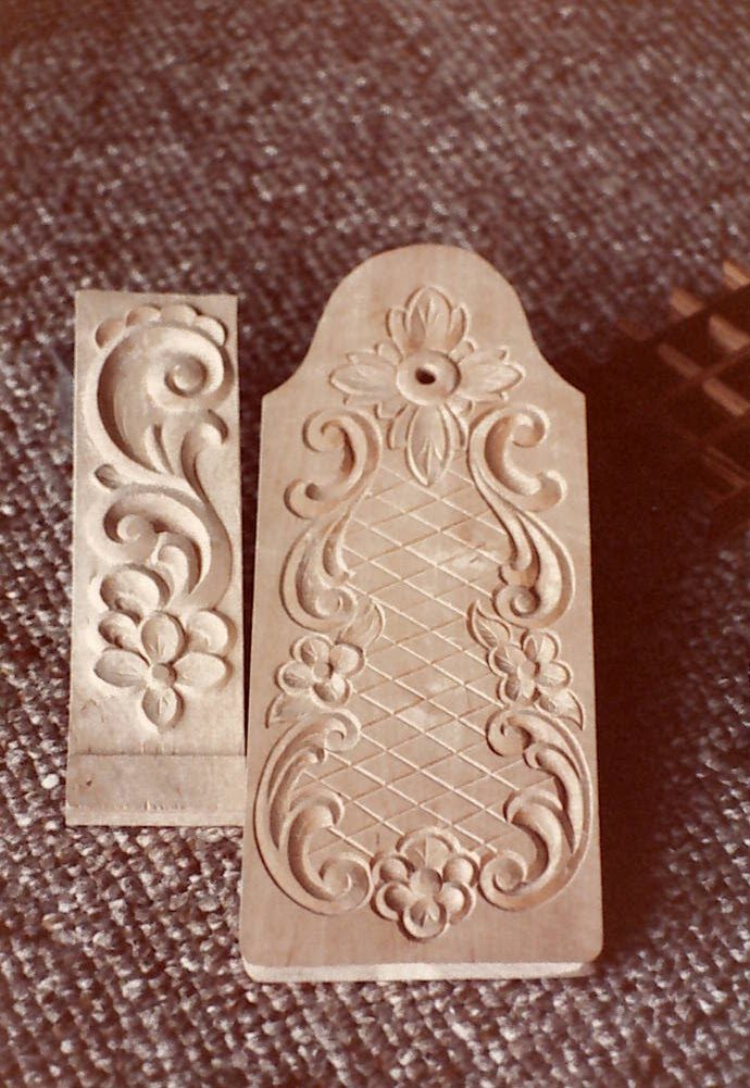 Two relief-carved panels with scrolls, flowers and a diamond lattice